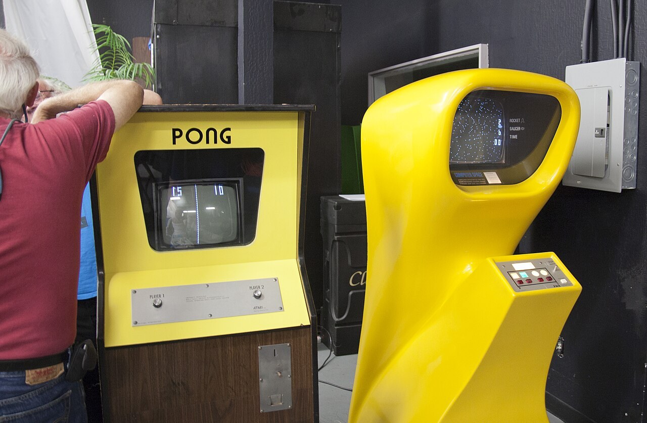 Pong and Computer Space arcade cabinets photographed at a Digital Game Museum event in 2012.