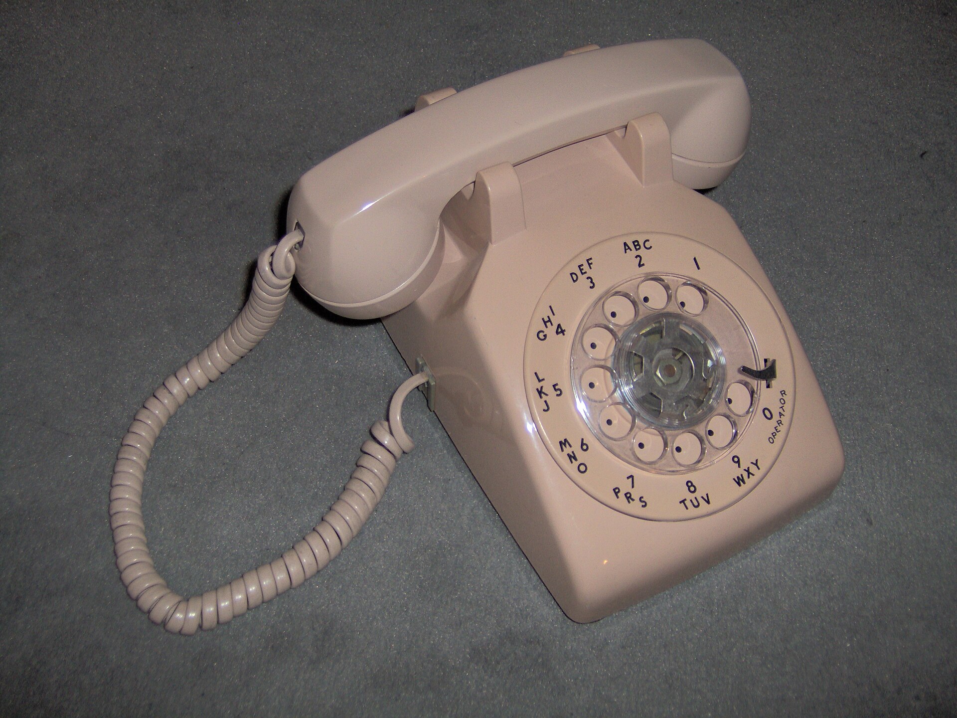 Beige Western Electric Model 500 rotary telephone and its coiled cord