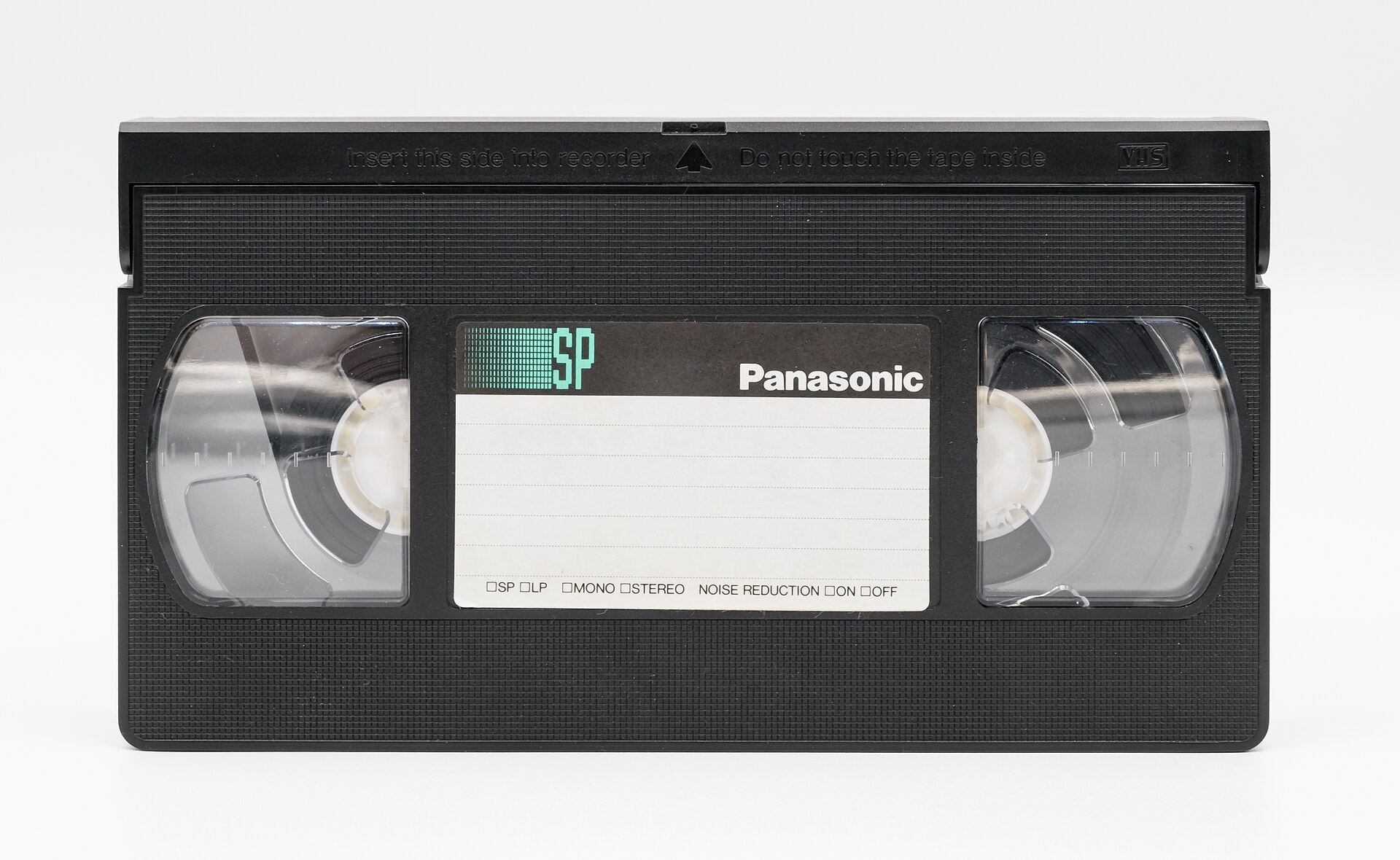 A black Panasonic VHS cassette with a blank white label